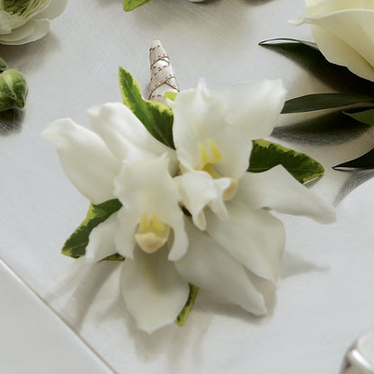 White Mini Cymbidium Boutonniere –  Newell Flower Shop Ltd., Kamloops BC